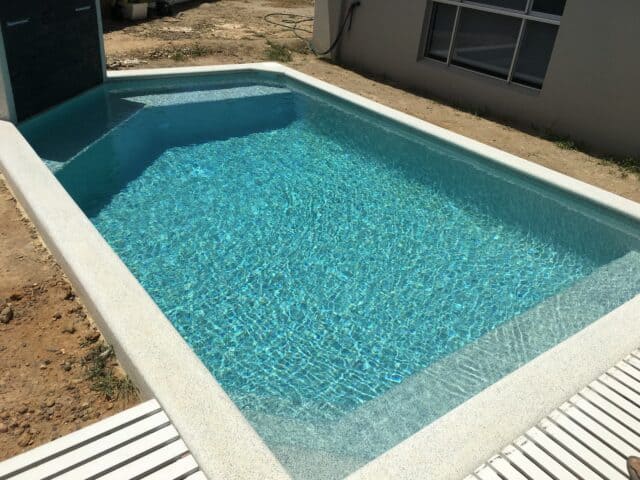 Pool built by Pools by Boris & Larry Batchelor. Pool finishes in Fijian Seas, exposed coping done in Kirra Blue.