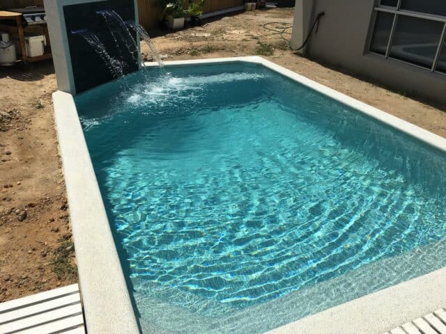 Pool built by Pools by Boris & Larry Batchelor. Pool finishes in Fijian Seas, exposed coping done in Kirra Blue.